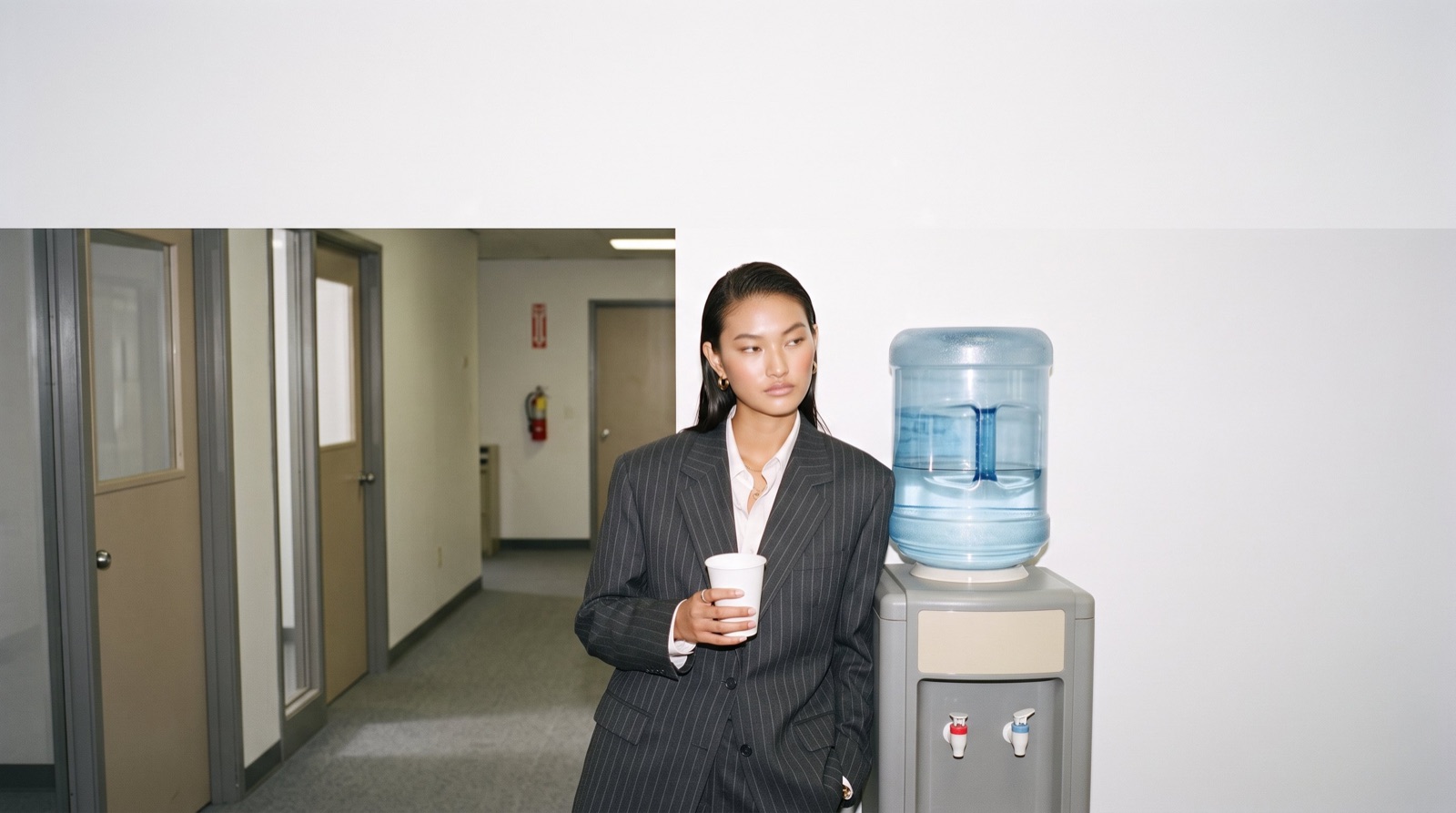 A founder by the water cooler in a grey office