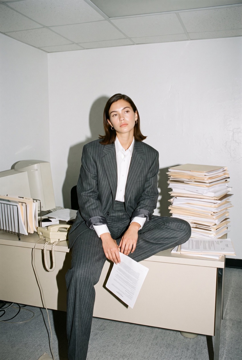 Maya sitting on a desk with papers