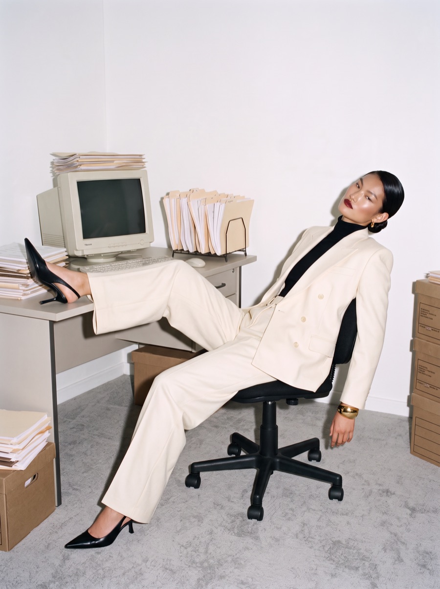 A founder leaning back in an office chair, one foot on the desk